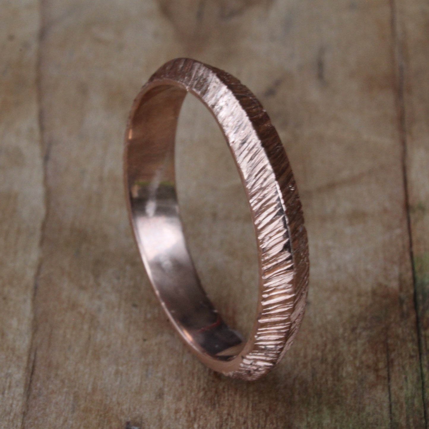 One-of-a-kind unisex ring crafted from 18ct rose/pink gold, featuring a distinctive ripple texture and rounded edges for comfort