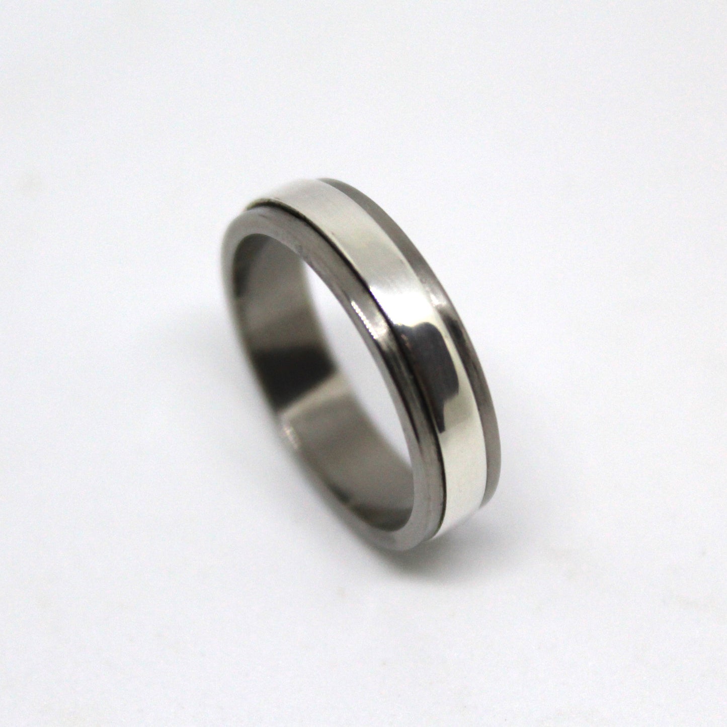 Sterling silver ring with a mechanical design that spins independently within a titanium housing, perfect for fidgeting and playful interaction