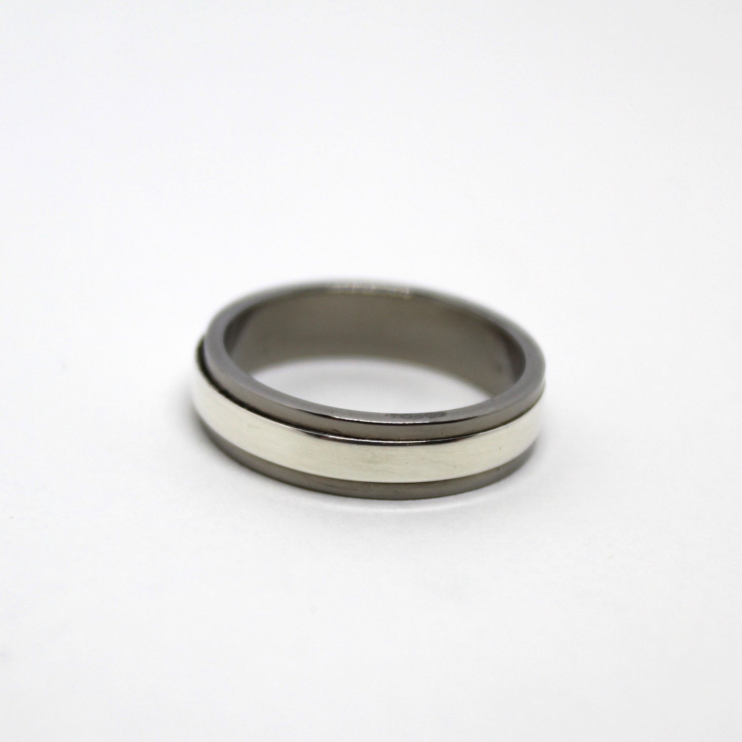 Sterling silver ring with a mechanical design that spins independently within a titanium housing, perfect for fidgeting and playful interaction