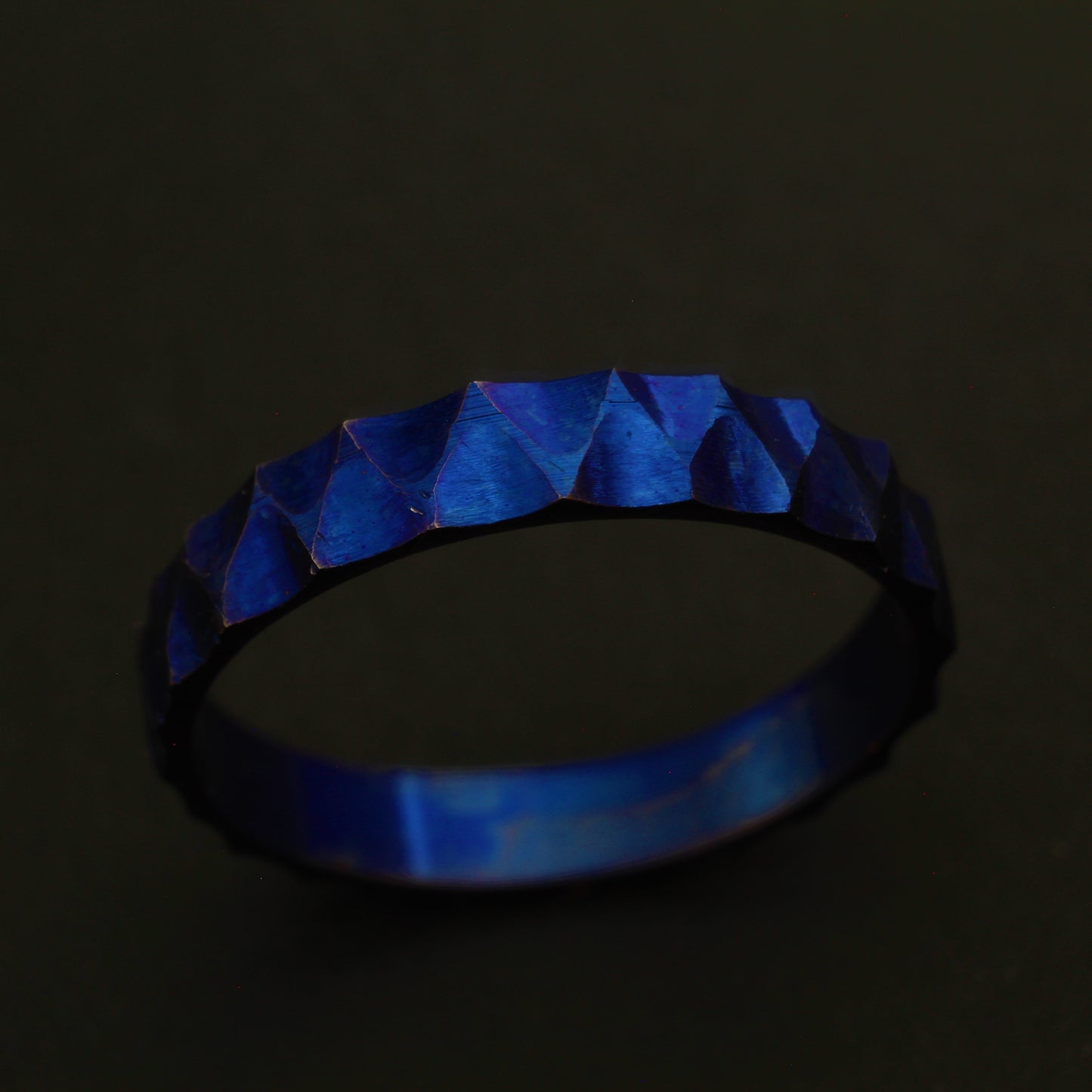 Anodized Titanium Ring with a vibrant blue hue, featuring a ridged and valley pattern for a sophisticated and elegant design.