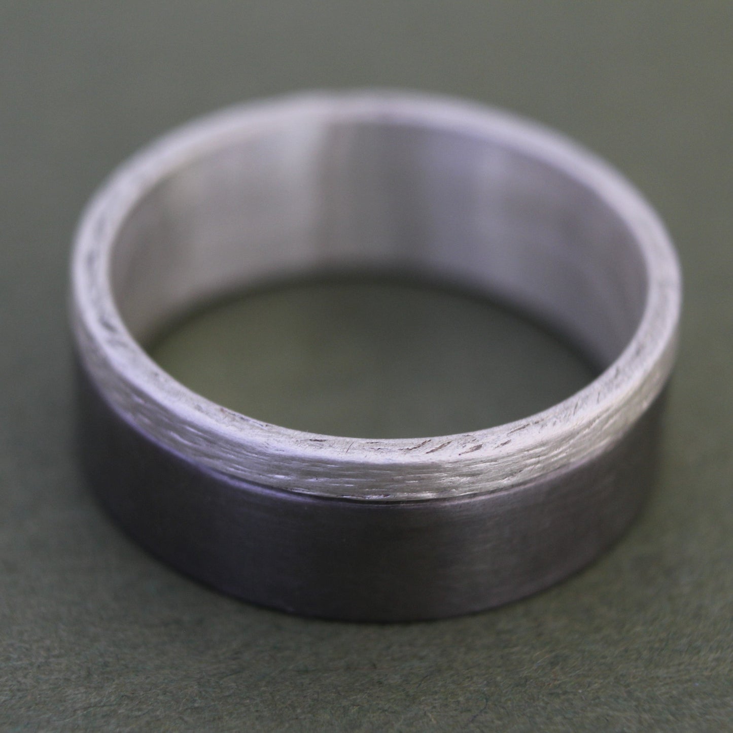 Men's Ring with a brushed titanium band and a textured sterling silver inlay, combining modern sleekness with sophisticated detail for a bold, elegant design.