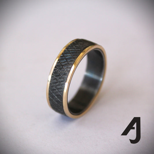 Gold and knurled black steel ring