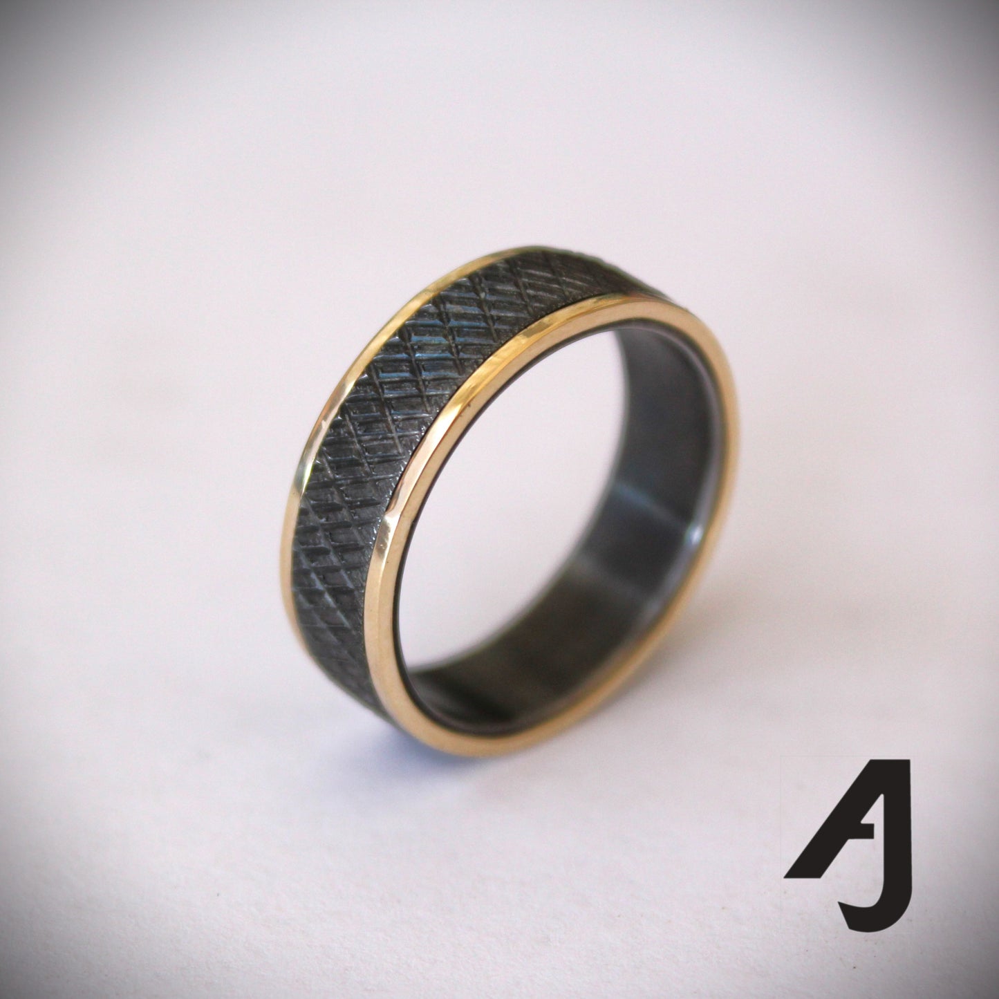 Gold and knurled black steel ring