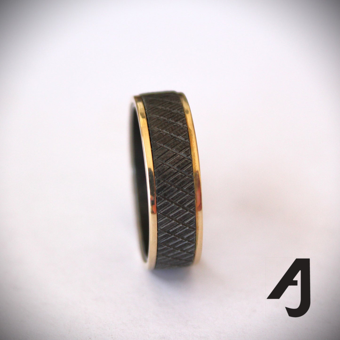 Gold and knurled black steel ring