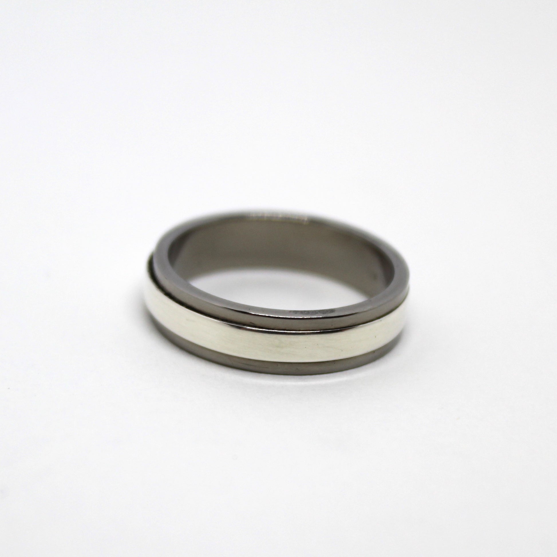 Sterling silver ring with a mechanical design that spins independently within a titanium housing, perfect for fidgeting and playful interaction