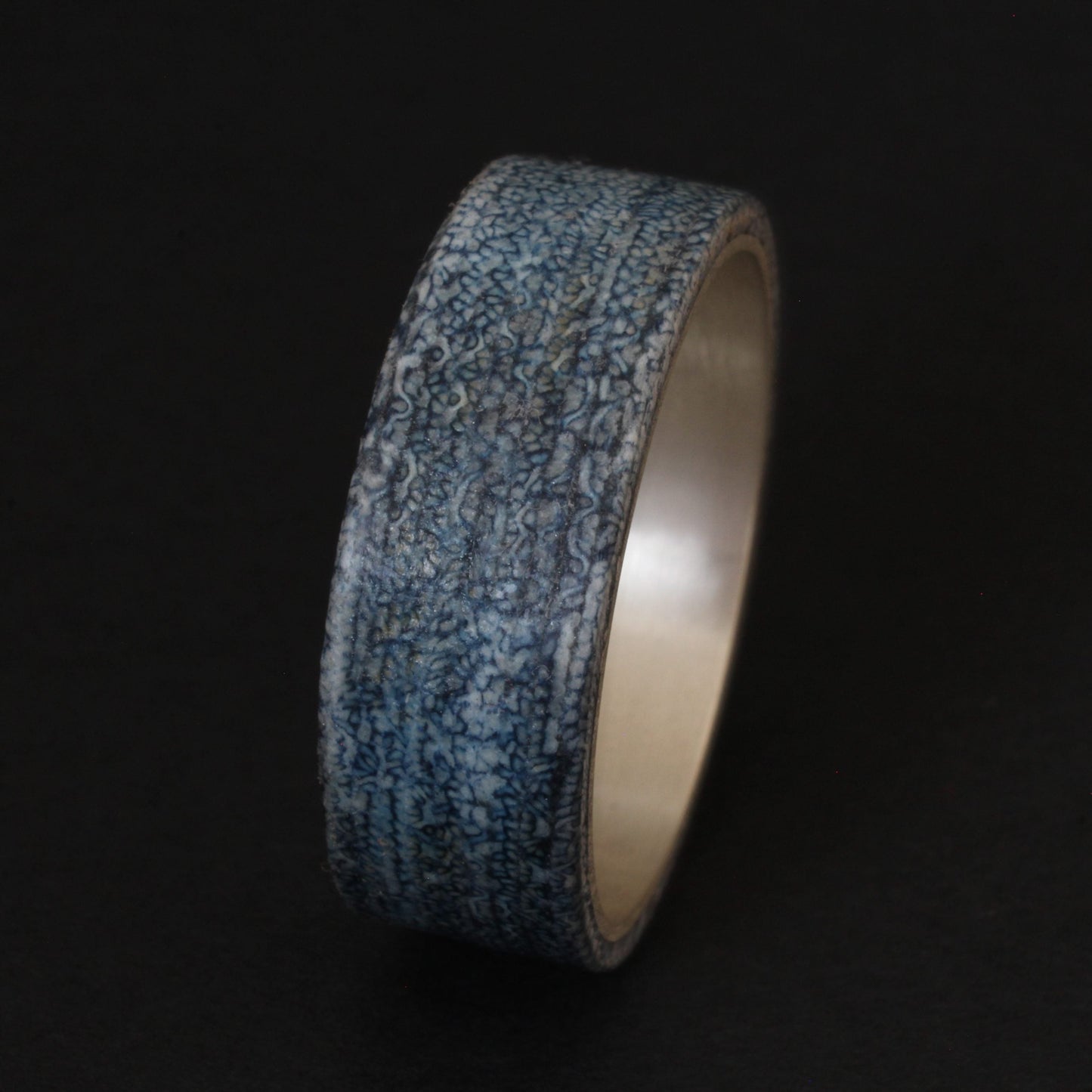 Denim and Sterling Silver Ring featuring a textured denim inlay with a sleek sterling silver band, combining casual and elegant elements for a unique, comfortable accessory.