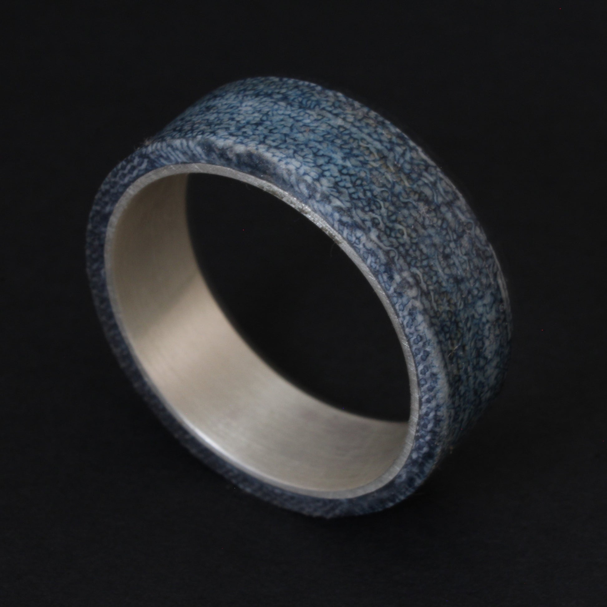 Denim and Sterling Silver Ring featuring a textured denim inlay with a sleek sterling silver band, combining casual and elegant elements for a unique, comfortable accessory.