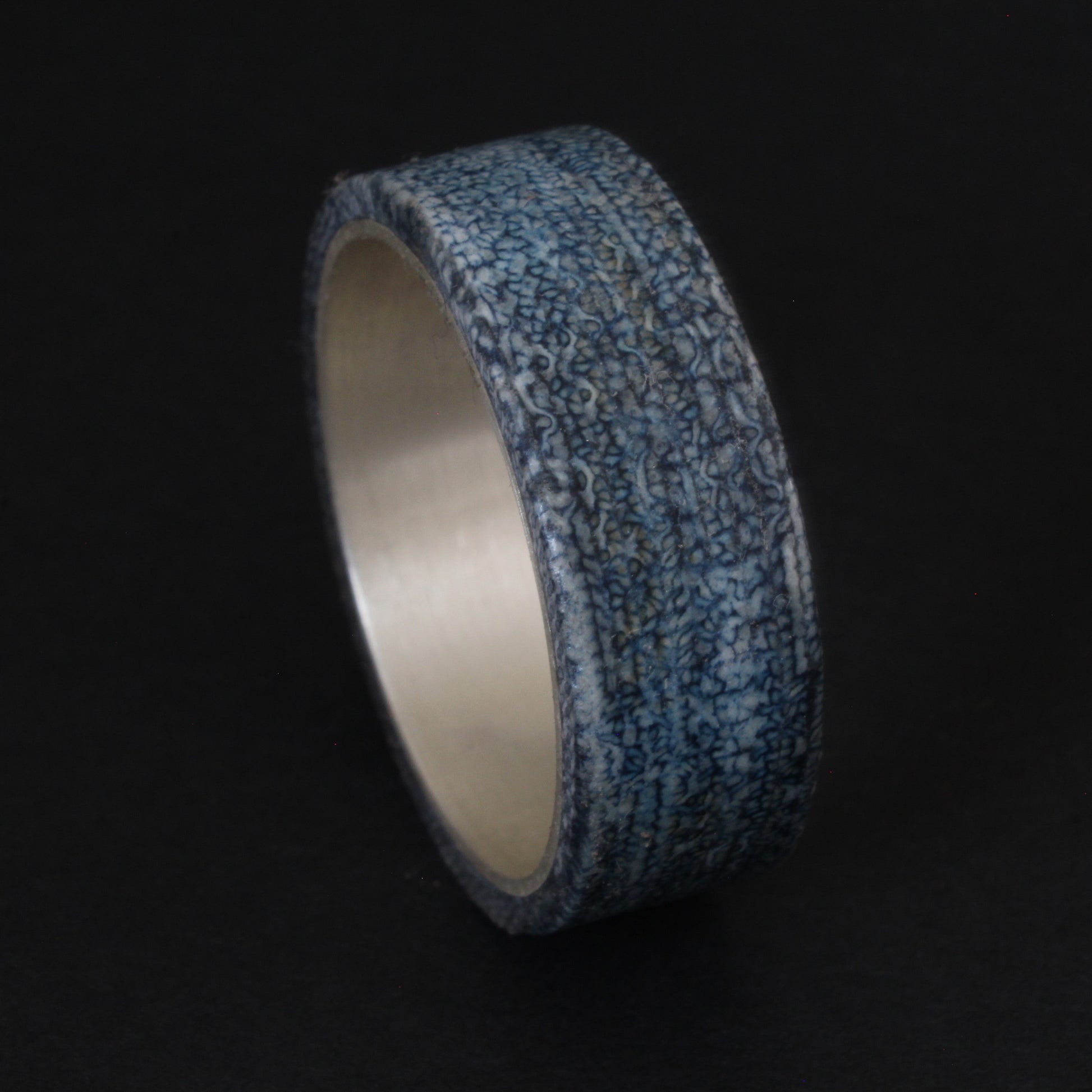 Denim and Sterling Silver Ring featuring a textured denim inlay with a sleek sterling silver band, combining casual and elegant elements for a unique, comfortable accessory.