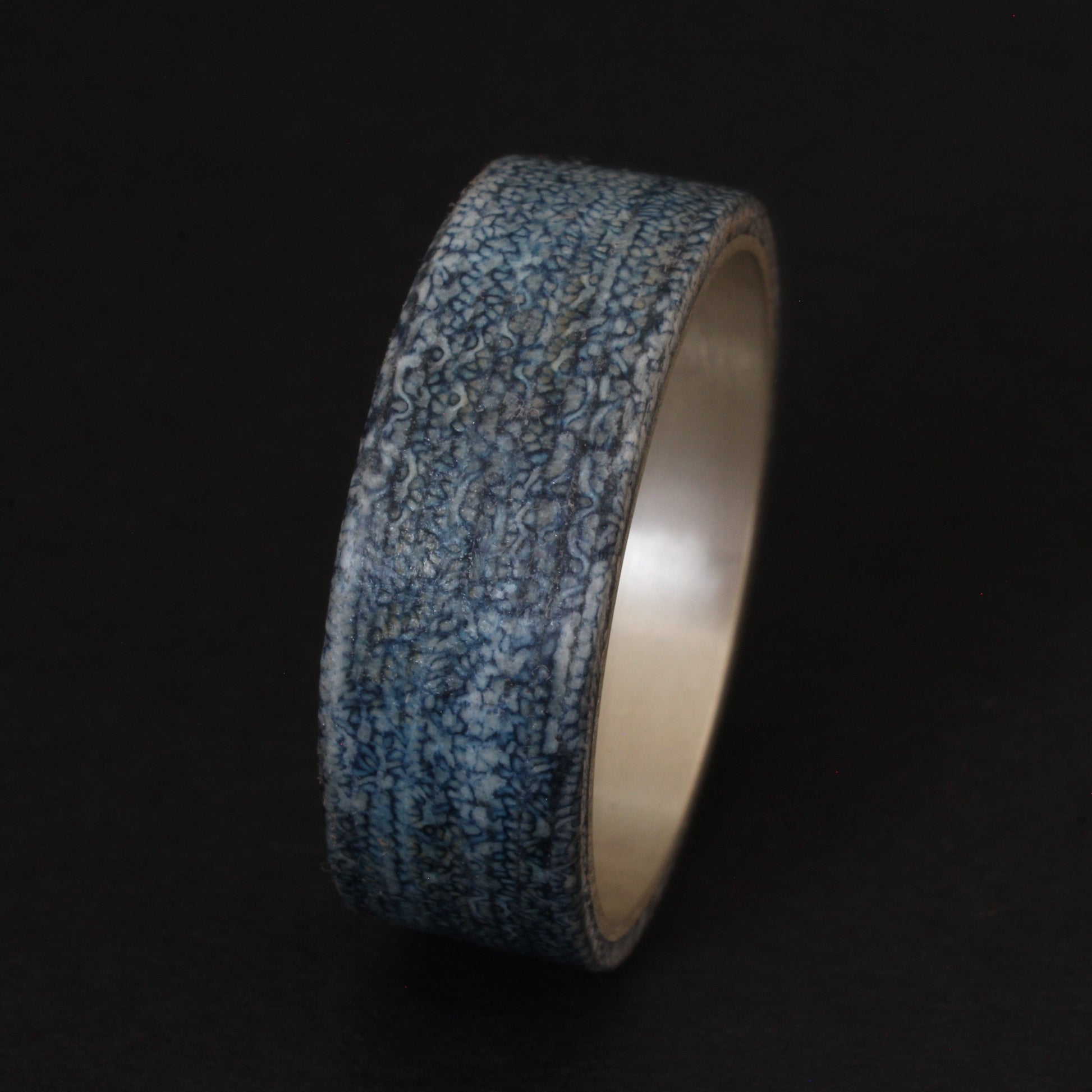 Denim and Sterling Silver Ring featuring a textured denim inlay with a sleek sterling silver band, combining casual and elegant elements for a unique, comfortable accessory.