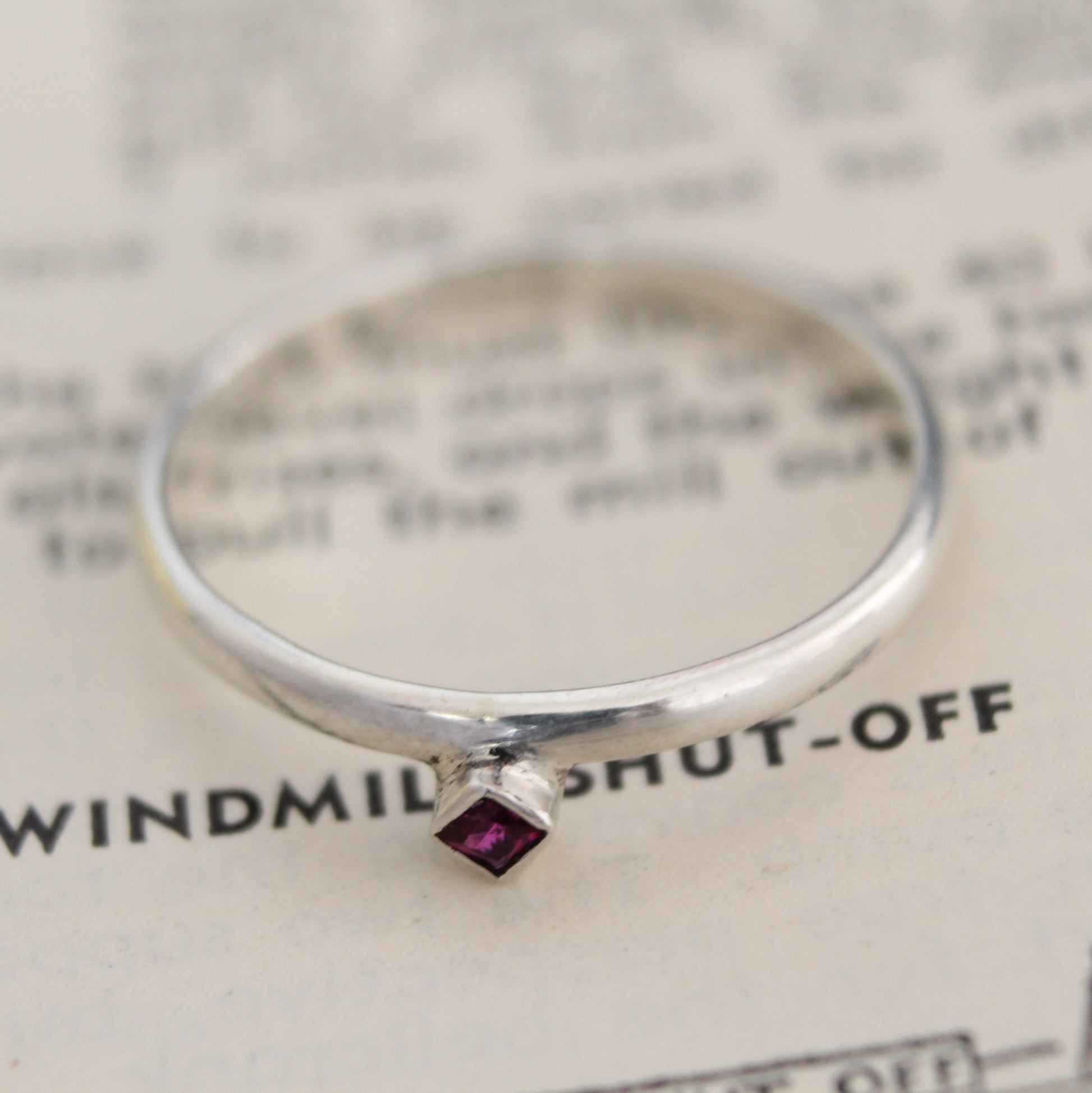 Handmade sterling silver ring with a bezel-set princess-cut ruby, showcasing a blend of modern design and timeless elegance. Thoughtfully crafted with intricate detail, perfect for both everyday wear and special occasions