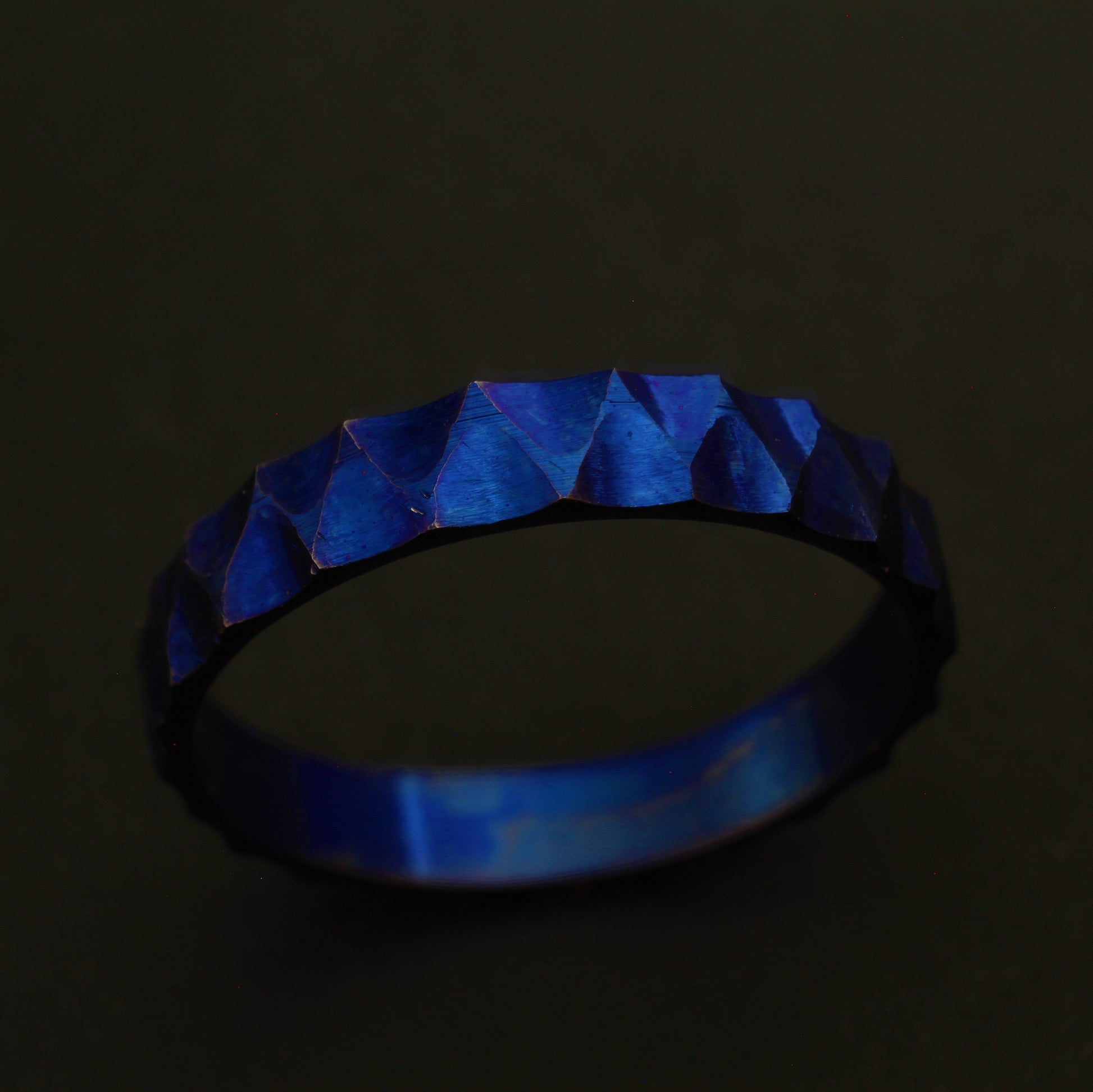 Anodized Titanium Ring with a vibrant blue hue, featuring a ridged and valley pattern for a sophisticated and elegant design.