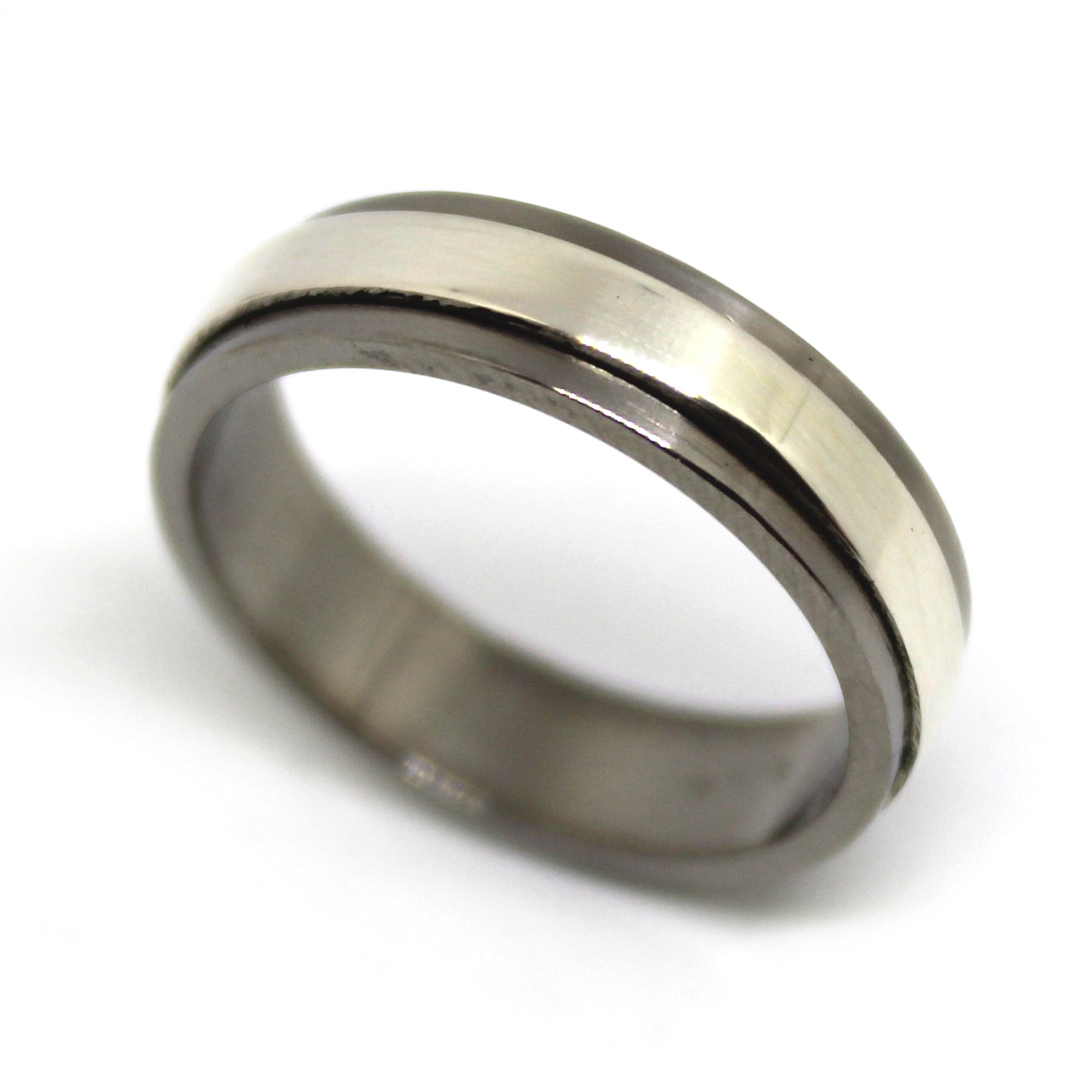 Sterling silver ring with a mechanical design that spins independently within a titanium housing, perfect for fidgeting and playful interaction