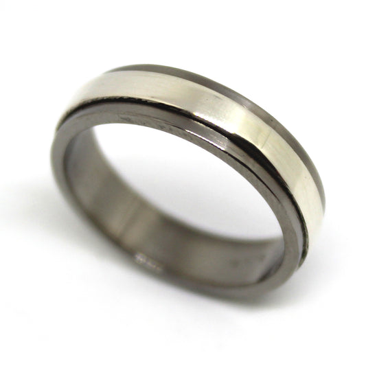 Sterling silver ring with a mechanical design that spins independently within a titanium housing, perfect for fidgeting and playful interaction